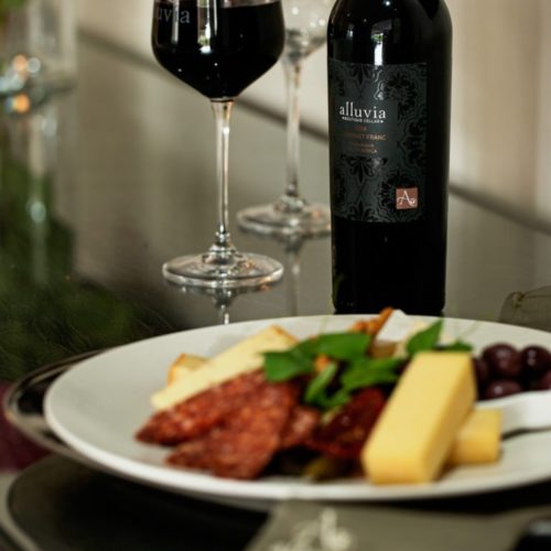 bottle of red wine and cheese platter