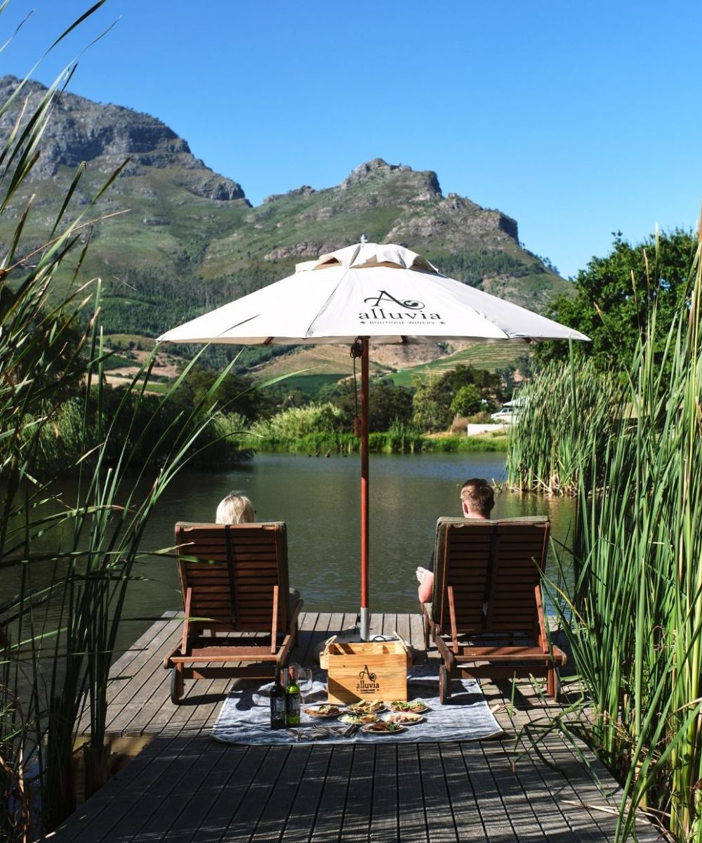 couple enjoying a picnic on the jetty at the dam